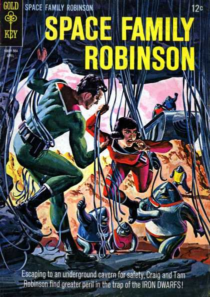 Space Family Robinson 12 - Man And Woman - Entangled In Wires - Escaping To An Underground Cavern For Safety - Craig And Tam Robinson Find Greater Peril - In The Trap Of The Iron Dwarfs